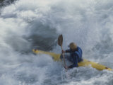 A Kayaker Paddles Through White-Water Rapids on the Snake River