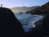 A Person Stands on an Overlook Above a Rocky Shoreline