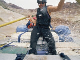 A Female Rafter Takes the Oars in a Raft Traveling Down the Colorado River
