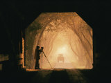A Photographer Sets up His Camera in a Covered Bridge