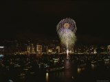 Fireworks Light up the Sky over a Boat-Filled Harbor at Night