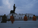 Buddhist Monks Meditate at a Statue of Buddha in Bangkok