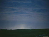 The Western Horizon is Silhouetted against a Night Sky