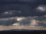 Rays of Sunlight Shine Through Clouds Above Albuquerque