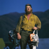 Portrait of a Fire-Fighter Holding a Chain Saw