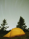 An Illuminated Tent under a Star-Streaked Sky