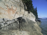 A Petroglyph Decorates a Waterside Cliff