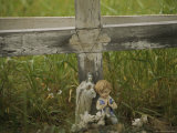 Small Statue and a Cross Draped with a Necklace Mark a Wayside Shrine