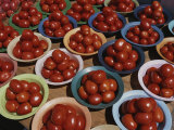 Roma Tomatoes Fill Colorful Bowls at a Vendors Stall