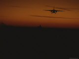 A Plane Comes in for a Landing on an Aircraft Carrier at Twilight