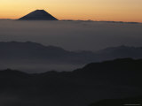 Distant View of Mount Fuji Silhouetted against an Orange Sky