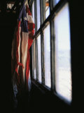 An American Flag Hangs in a Window