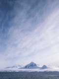 A Distant View of Mountains on Wienke Island  under a Cloudy Sky
