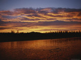 An Intense Sunset Colors Clouds and the Water of the Mackenzie River