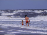 A Man and Child Play in the Assateague Island Surf