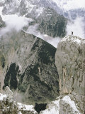 View of Snow-Covered Peaks with the Tiny Figure of a Climber Atop One