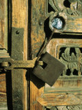 A Doorway with an Ornately Carved Latch and Window