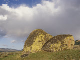 Lichen-Covered Glacial Erratic Boulders under a Cloudy Sky