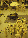 Journalists  Engineers and Technicians Examine a Robot in a Clean Room