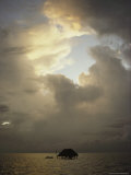 A Fishermans Elevated Water-Bound Hut under a Cloud-Filled Sky