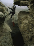 A Caver Climbs out of Majlis Al Jinn