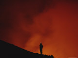 A Scientist Stands Silhouetted by an Enormous Plume of Orange Smoke at Mount Etna