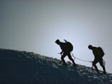 Hikers Trudge Along an Ice-Encrusted Ridge