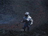 A Scientist in Full Thermal Suit and Helmet Gathers Lava Samples