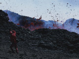 A Man Shields His Face from Falling Lava Bombs on Mount Etna