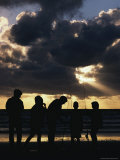 Silhouetted Fishermen on the Shore at Twilight