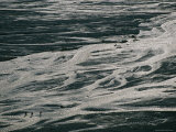An Aerial View of Hikers Crossing a Braided Riverbed