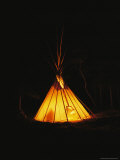 The Glow from a Campfire Makes a Shadow on a Tepee