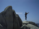 A Man Leaps from Rocks Surrounding Monterey Bay  Near Carmel