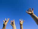 Childrens Hands Reach Toward the Blue Sky