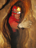 Man in Caving Gear in the Entrance to the Laundry Chute  a Narrow Corridor in the Rats Nest Cave