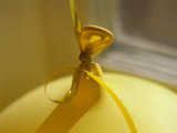 Close View of a Yellow Balloon Tied with a Curly Ribbon