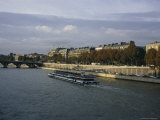 A Tourist Boat Cruises Along the Seine River