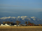 Houses and Fields Before the Looming Rocky Mountains