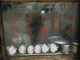 Teapots on the Sill of a Restaurant Window Covered with Steam