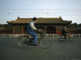 Man on a Bicycle Passes by the Back of the Forbidden City