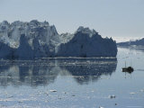 Fishing Boat Maneuvers Around Icebergs near the Ilulissat Glacier