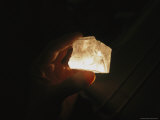 Close View of a Hand Holding an Illuminated Salt Crystal