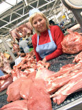 A Butcher Sells Meat at the Food Market