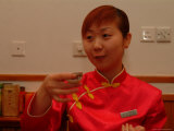 A Salesperson Prepares Samples of Tea for Tourists
