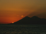 Sun Disappearing Behind Mountains at Sunset