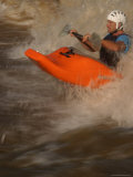 Kayaker Surfing Whitewater Wave