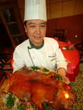 A Chef at the St Regis Hotel Displays a Platter of Pork