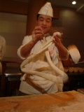 Chef Twirls Dough as He Makes Fresh Noodles in a Restaurant