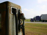 The Blur of a Truck Passing a Vintage Gas Pump