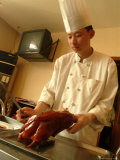 A Chef Prepares Beijing Duck in a Restaurant